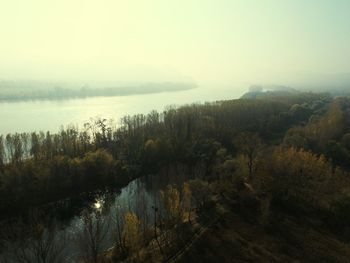 Scenic view of lake in forest against sky