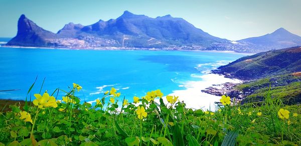 Scenic view of sea and mountains against sky