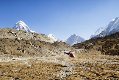 Helicopter landing on mt. everest against clear blue sky