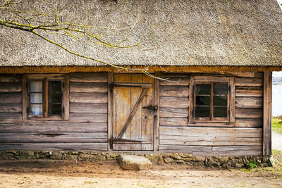 Exterior of an old wooden house on a sunny spring day