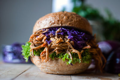 Close-up of burgers served on wooden table