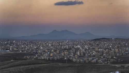 High angle shot of townscape against sky at sunset