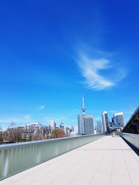 Buildings in city against blue sky