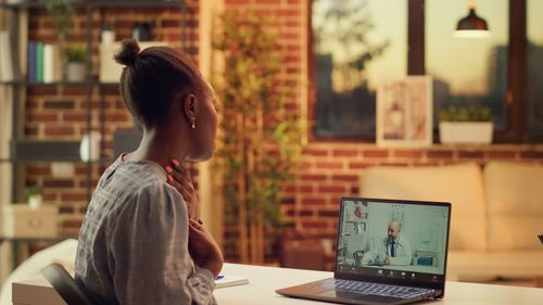 Young woman using laptop at table