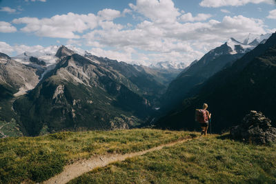 Rear view of woman standing on mountain