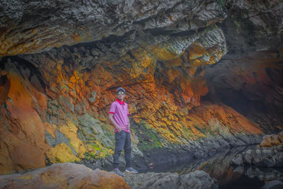 Full length of man standing on rock