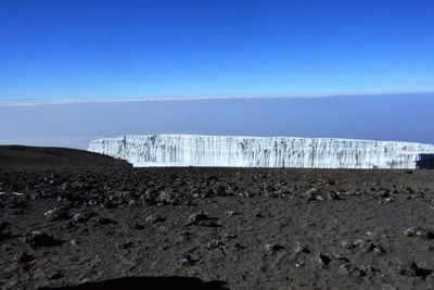 Scenic view of mountains against clear blue sky