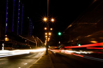 Light trails on road in city at night