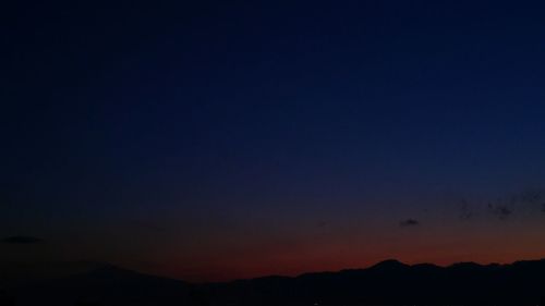 Scenic view of silhouette mountain against sky at night