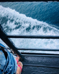Low section of person on sea shore