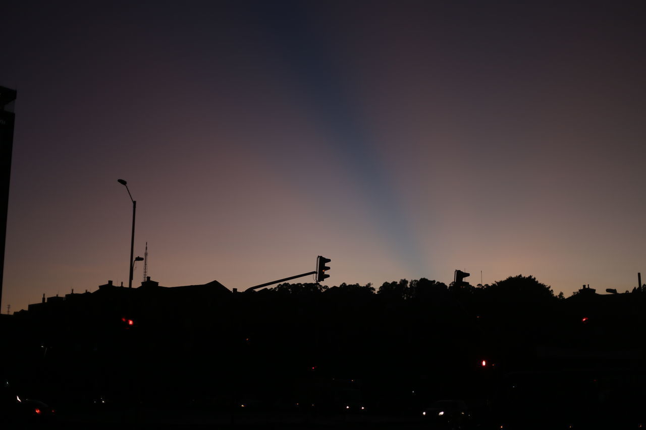 SILHOUETTE STREET LIGHT BY BUILDING AGAINST SKY AT SUNSET