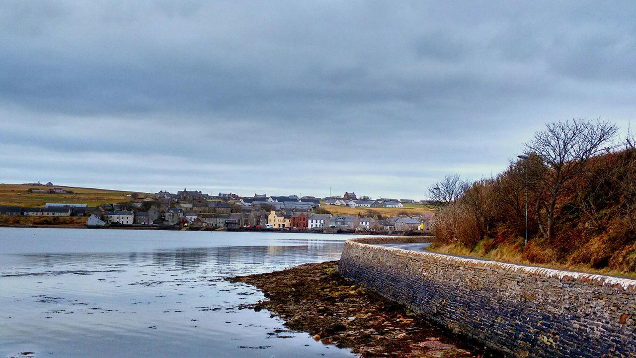 building exterior, architecture, built structure, sky, water, cloud - sky, river, cloudy, tree, cloud, house, city, residential structure, weather, residential building, canal, day, outdoors, no people, overcast