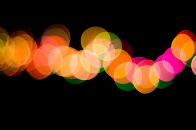 Close-up of illuminated lights against black background