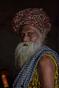 Close-up portrait of man wearing headdress at home