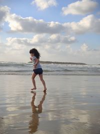 A little girl is running on the surf line