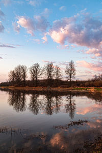 Scenic view of lake against sky at sunrise 