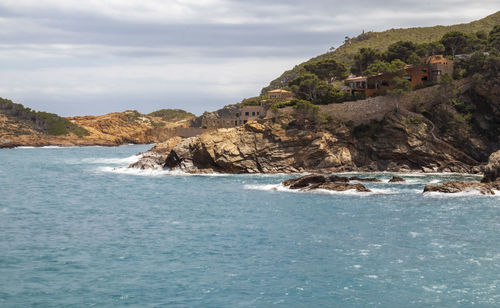 Scenic view of sea and buildings against sky