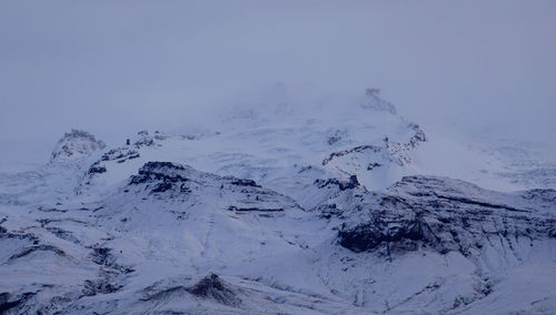 Aerial view of snow covered mountain against sky