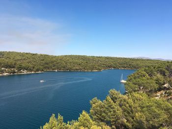 Scenic view of sea against clear blue sky