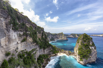 Scenic view of cliff and sea against sky