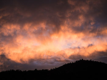 Scenic view of silhouette forest against sky at sunset