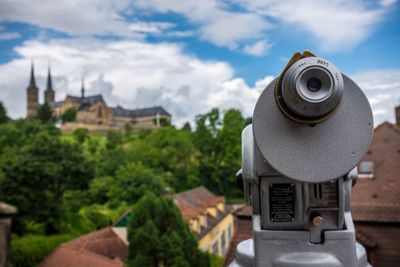 Close-up of hand-held telescope against michaelsberg abbey