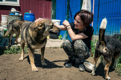 Side view of woman with dogs at beach