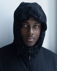 African american male with blue eyes in the cold with hoodie on