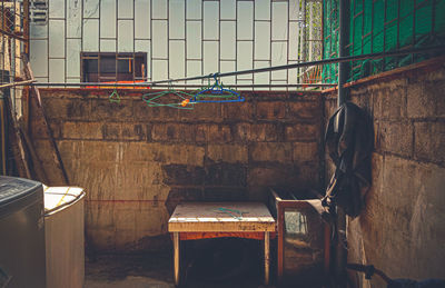 Empty chairs against wall in old building