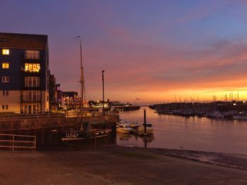 Boats in harbor at sunset