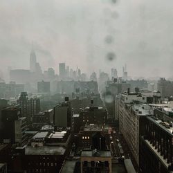 High angle view of buildings in city against sky