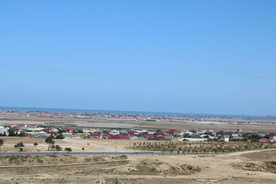 Scenic view of beach against blue sky