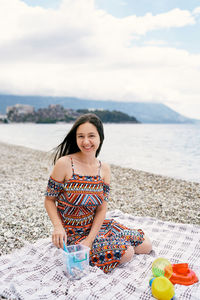 Portrait of smiling young woman on beach