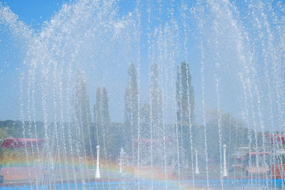 Water splashing on fountain against sky in city