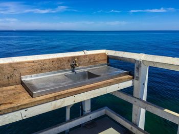 Sink on pier by sea against sky