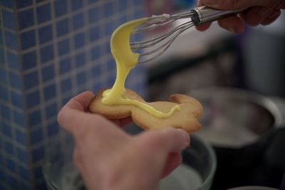 Cropped image of person holding cookies