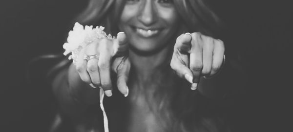 Close-up of a smiling young woman over black background