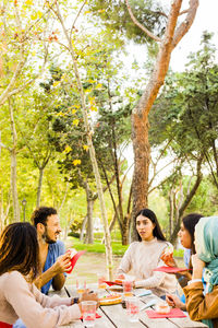 Rear view of woman sitting in park