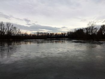 Scenic view of lake against sky during winter