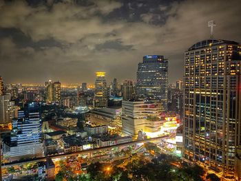 High angle view of illuminated buildings against sky at night