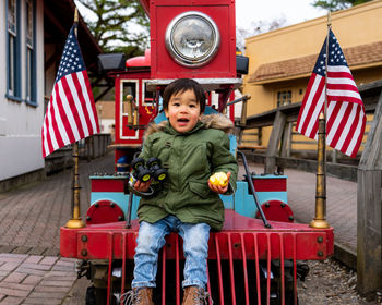 Portrait of smiling boy sitting on the train