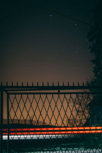 Fence against clear sky at night