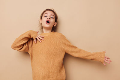 Portrait of girl against beige background