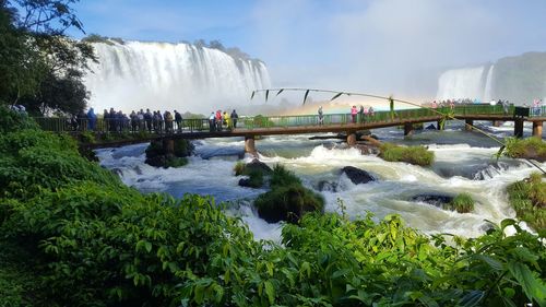 Scenic view of waterfall against sky