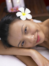 Portrait of woman having spa treatment while lying on massage table