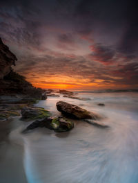 Scenic view of sea against sky during sunrise with wave flowing