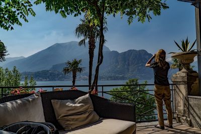 Rear view of people on chair by mountains against sky