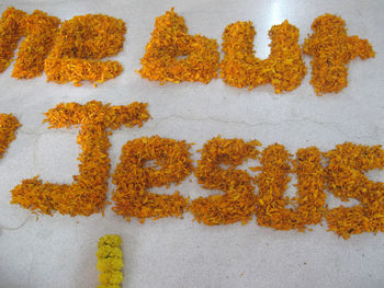 High angle view of fresh orange flowers on table