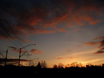 Low angle view of silhouette trees against sky during sunset