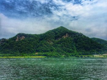 Calm countryside lake against mountain range